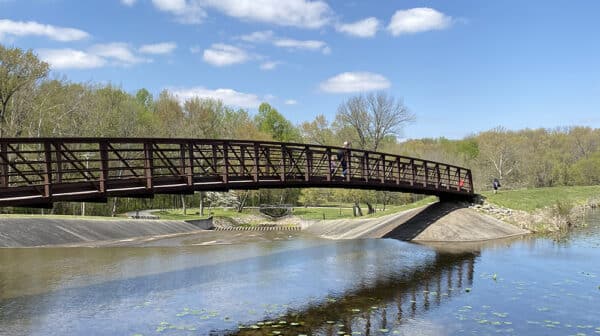 Brown bridge spans over Lake Lincoln at Lincoln State Park with trees in the background